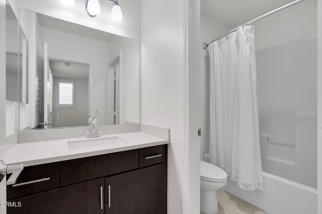 900 North Primrose Lane, Unit A Azusa, CA 91702 - Photo 38 of 55 a bathroom with a sink a toilet a mirror and shower