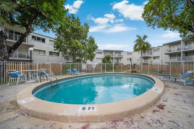 a view of a yard with swimming pool and sitting area