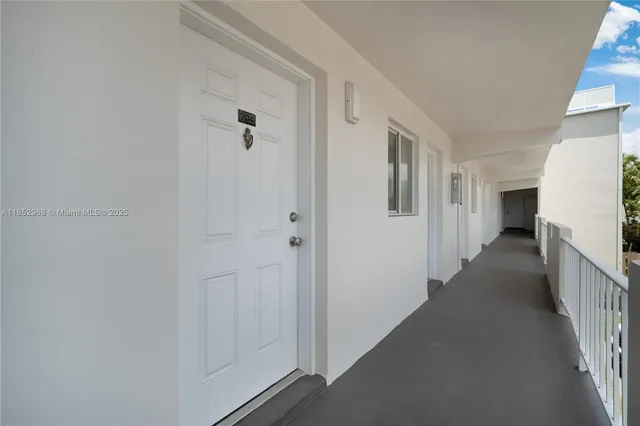 a view of a hallway with two windows