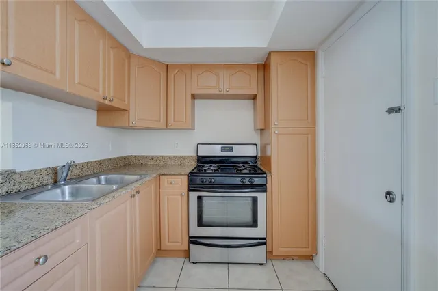 a kitchen with stainless steel appliances granite countertop a refrigerator and cabinets