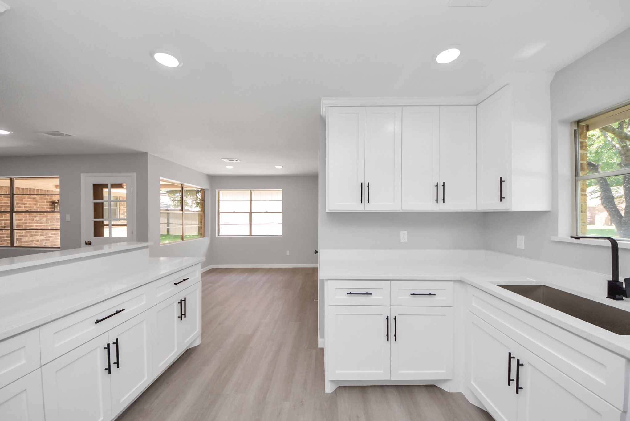 2402 Rolling Glen Drive Spring, TX 77373 - Photo 15 of 38 a kitchen with white cabinets and sink