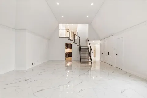 a view of an empty room with stairs