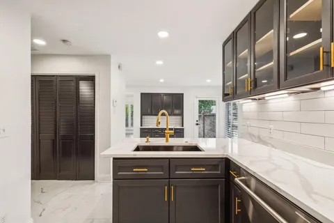 a kitchen with a sink and cabinets