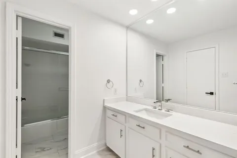 a bathroom with a double vanity sink and a mirror
