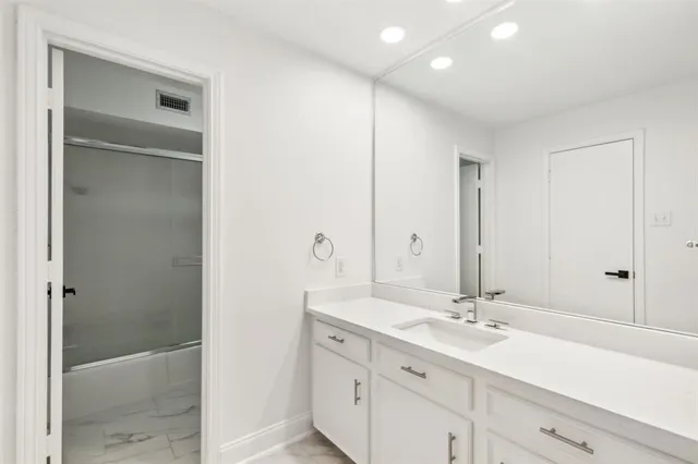 a bathroom with a double vanity sink and a mirror