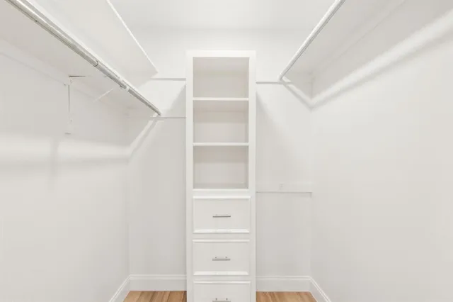 a view of walk in closet with empty racks
