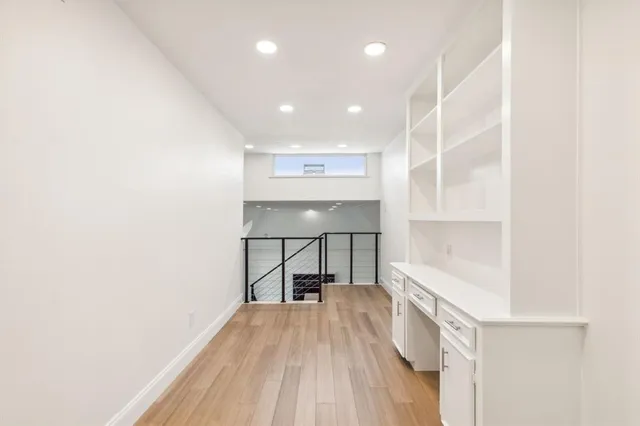 a view of a room with wooden floor