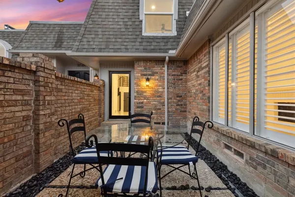 a view of a patio with table and chairs and wooden floor