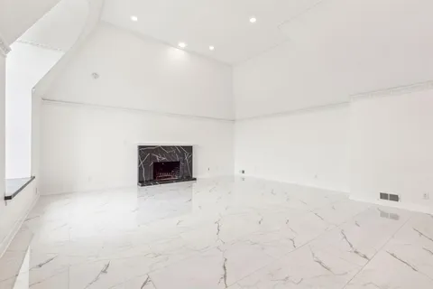 an empty room with white walls and tiles