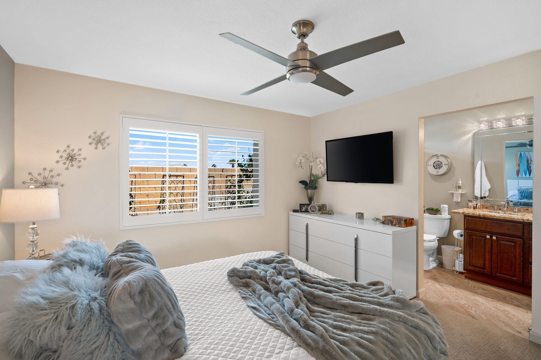 47800 Madison Street, Unit 100 Indio, CA 92201 - Photo 15 of 28 a living room with furniture a flat screen tv and a window