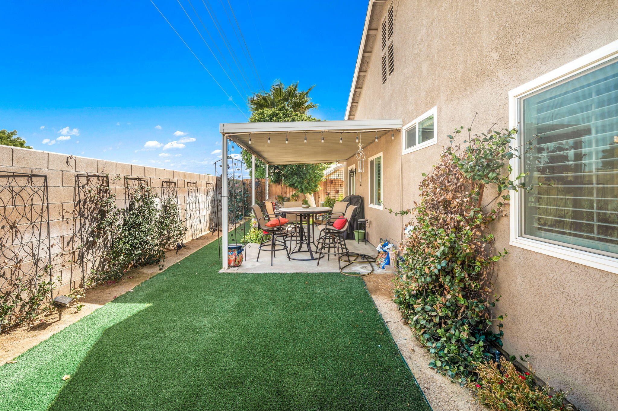 47800 Madison Street, Unit 100 Indio, CA 92201 - Photo 23 of 28 a view of a patio with table and chairs and potted plants