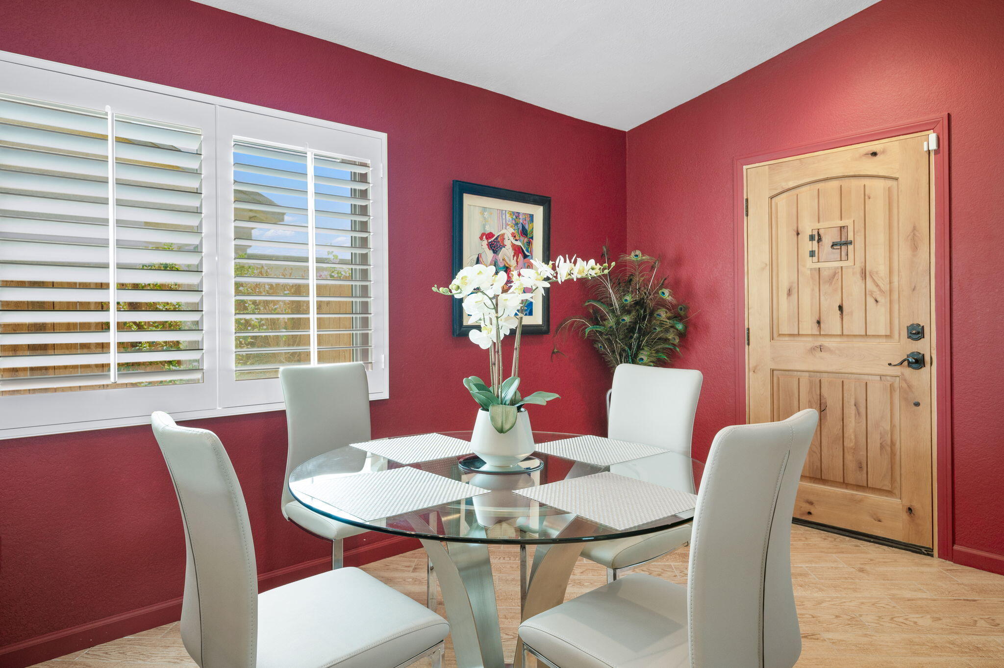 47800 Madison Street, Unit 100 Indio, CA 92201 - Photo 4 of 28 a view of a dining room with furniture a potted plant and wooden floor