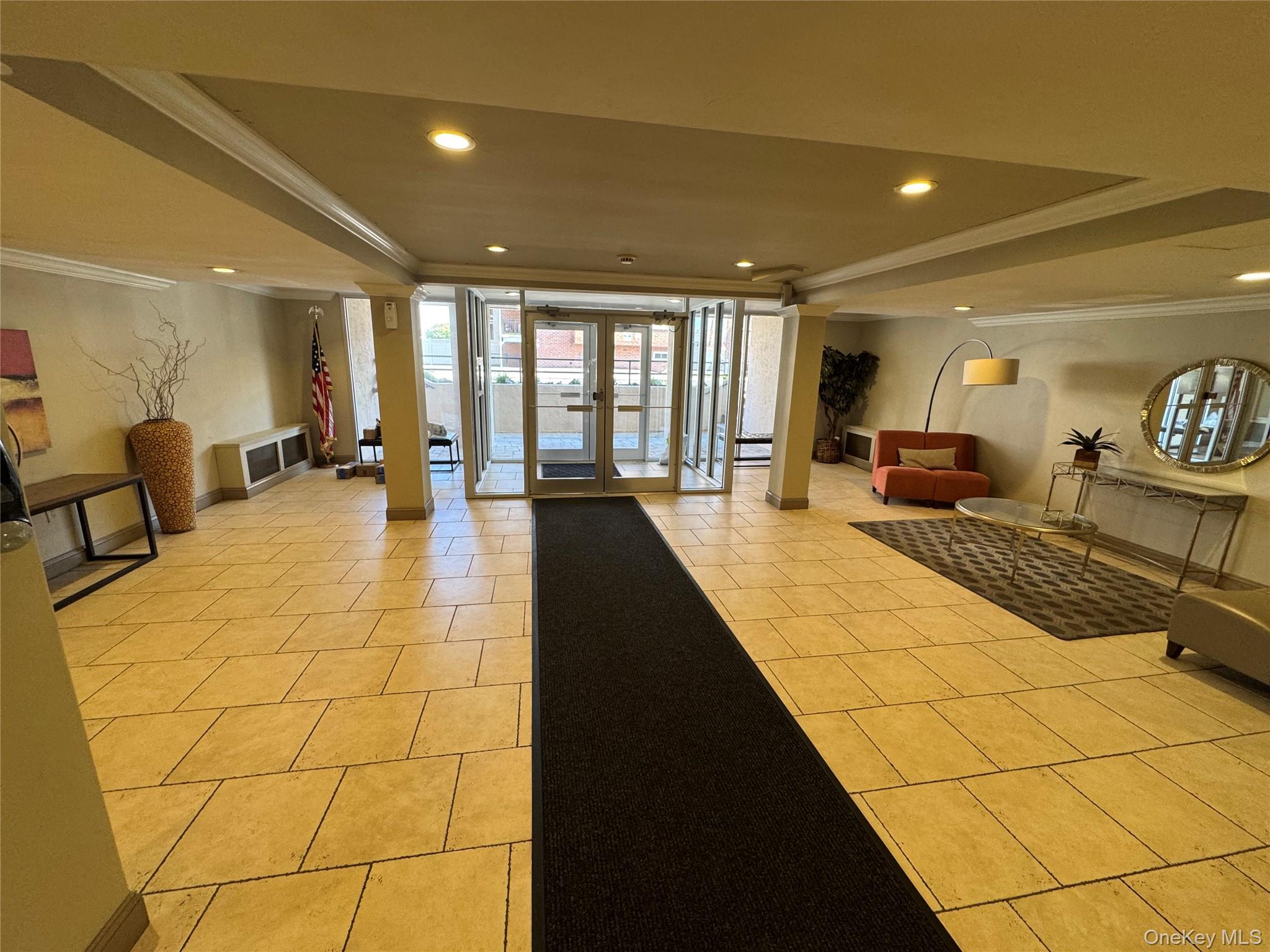750 Shore Road, Unit 4N Long Beach, NY 11561 - Photo 3 of 14 a lobby with furniture and large window