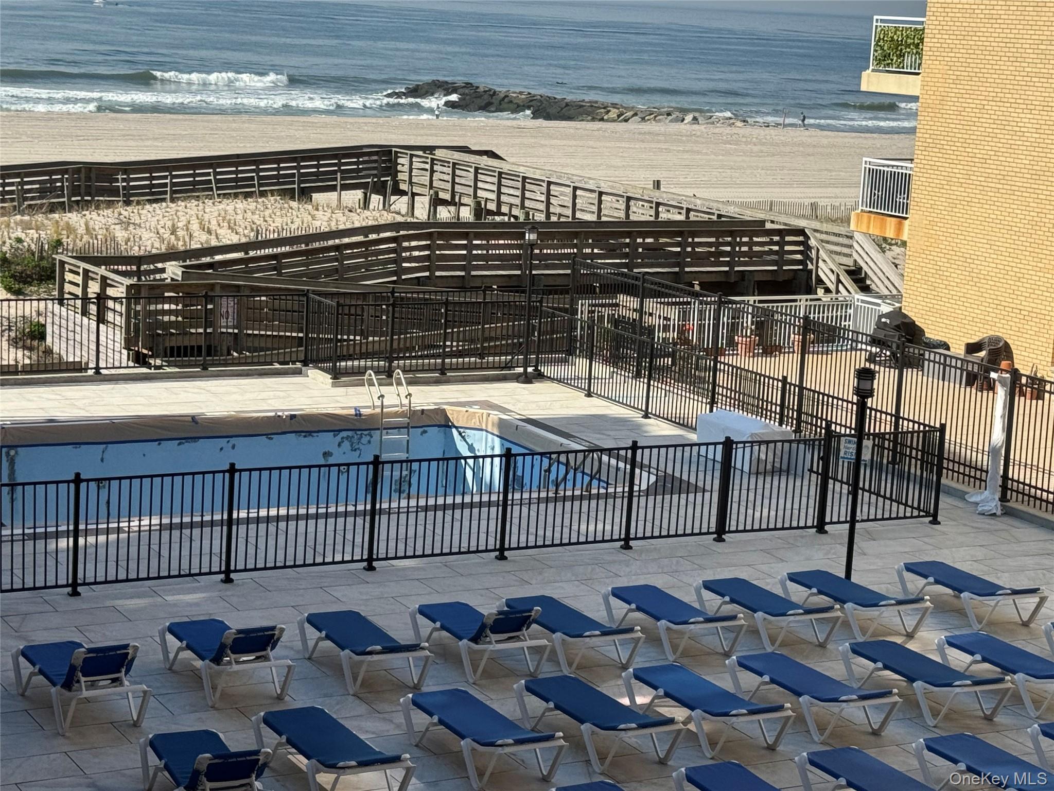 750 Shore Road, Unit 4N Long Beach, NY 11561 - Photo 8 of 14 a roof deck with couches and potted plants