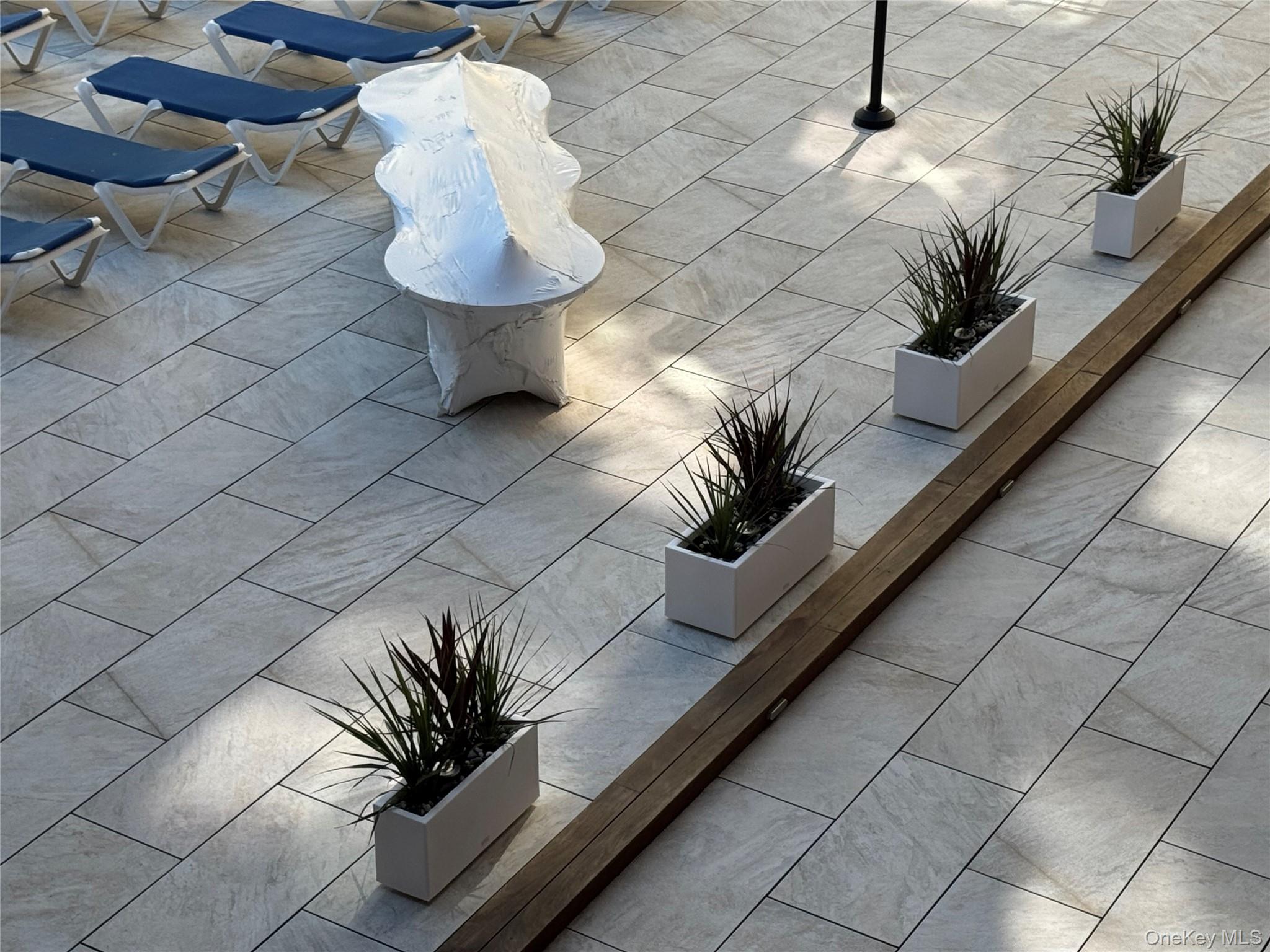 750 Shore Road, Unit 4N Long Beach, NY 11561 - Photo 10 of 14 a vase of flowers sitting on a floor