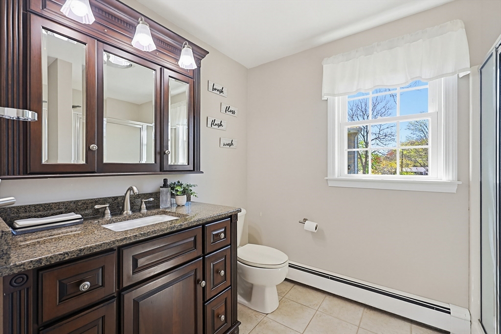 18 Anchorage Road Franklin, MA 02038 - Photo 21 of 42 a bathroom with a granite countertop toilet sink and mirror