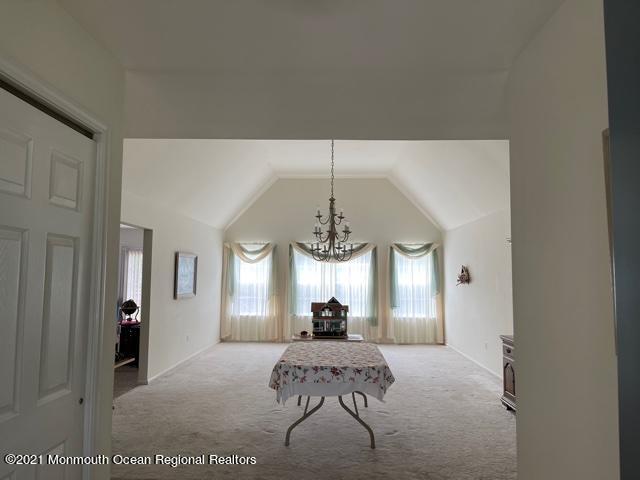133 Compass Road Manahawkin, NJ 08050 - Photo 11 of 27 a living room with furniture chandelier and a window
