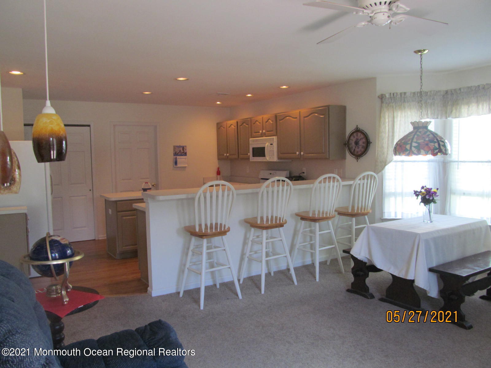 133 Compass Road Manahawkin, NJ 08050 - Photo 9 of 27 a dining room with furniture and a chandelier
