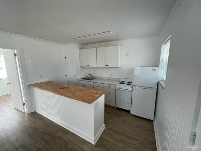 a kitchen that has a sink and a stove in it