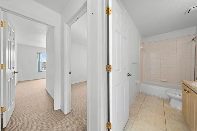 a bathroom with a granite countertop sink a toilet and shower