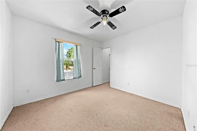 an empty room that has a grey walls