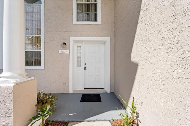 a view of an empty room and a chandelier fan