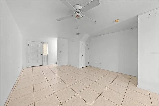 a view of an empty room and stairs