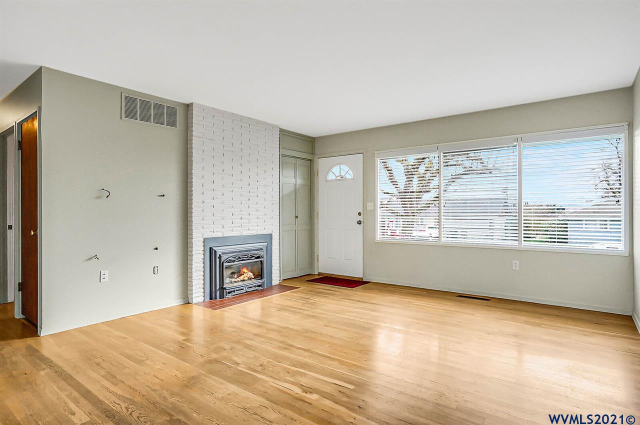 156 Northwest Reed Lane Dallas, OR 97338 - Photo 5 of 39 a view of an empty room with a fireplace and a window