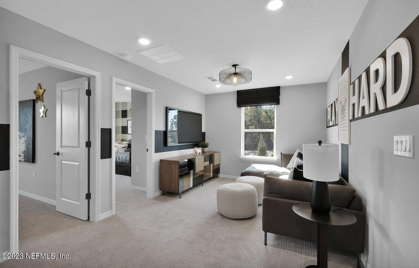 677 Blind Oak Cir Street St. Augustine, FL 32095 - Photo 9 of 19 a living room with furniture and a flat screen tv