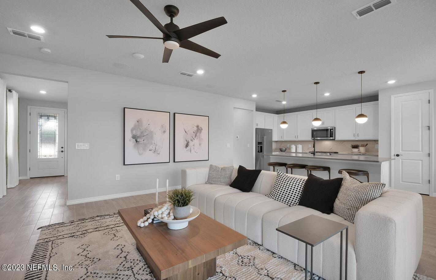 677 Blind Oak Cir Street St. Augustine, FL 32095 - Photo 12 of 19 a living room with furniture and kitchen view
