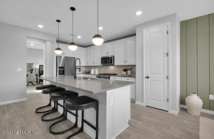677 Blind Oak Cir Street St. Augustine, FL 32095 - Photo 6 of 19 a kitchen with cabinets and chairs