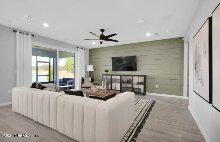 677 Blind Oak Cir Street St. Augustine, FL 32095 - Photo 7 of 19 a bedroom with furniture a flat screen tv and a chandelier