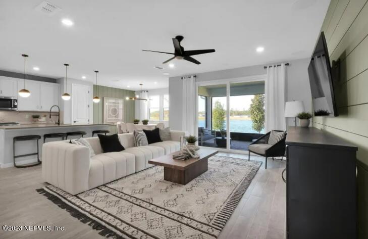 677 Blind Oak Cir Street St. Augustine, FL 32095 - Photo 8 of 19 a living room with fireplace furniture and a flat screen tv