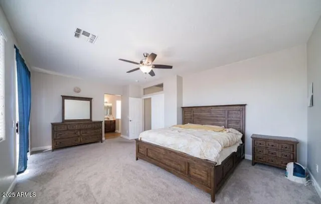 a bedroom with a bed and a dresser