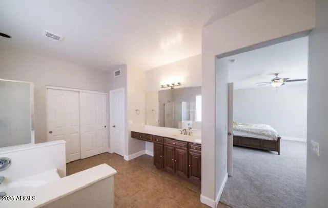 a en suite bathroom with a tub shower and sink
