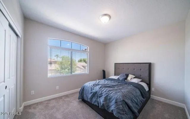 a bed sitting in a bedroom next to a window