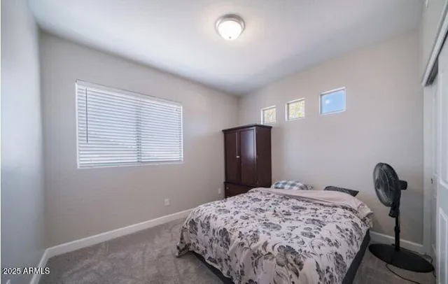 a bedroom with a bed and a window