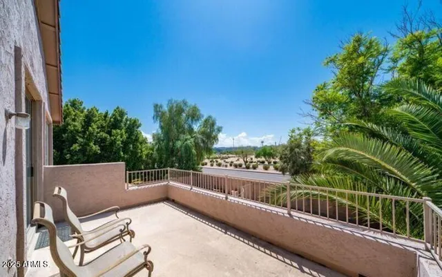 a view of roof deck with two chairs and a table