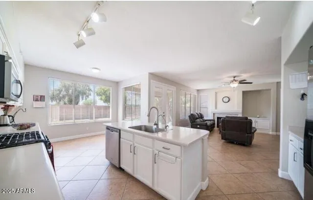 a bathroom with a double vanity sink a mirror and a bathtub