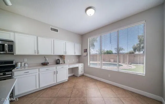 a kitchen with a sink window and cabinets