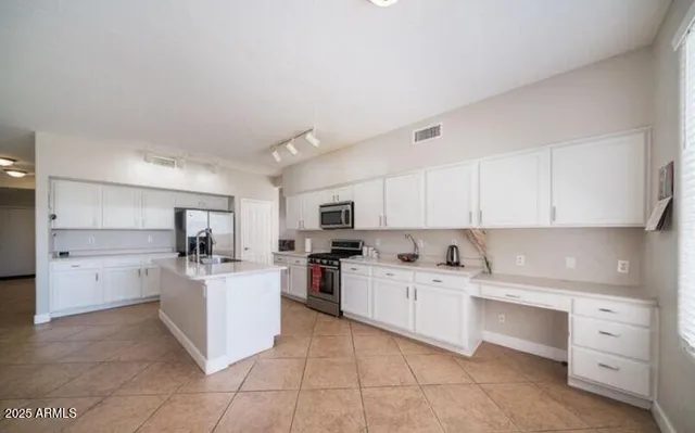 a kitchen with appliances cabinets and a sink