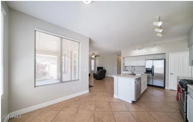 a kitchen with a stove top oven and refrigerator