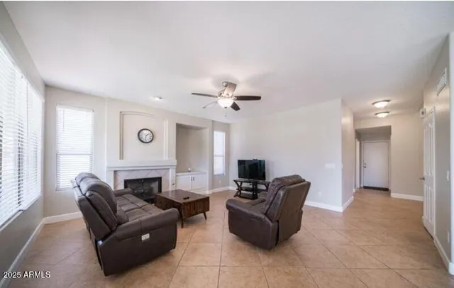 a living room with furniture flat screen tv and a fireplace