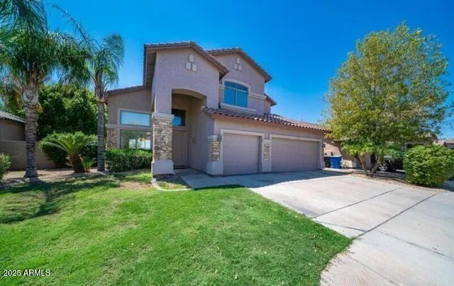 a front view of a house with a yard and garage