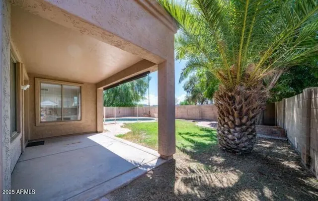 a view of a porch with furniture and a yard