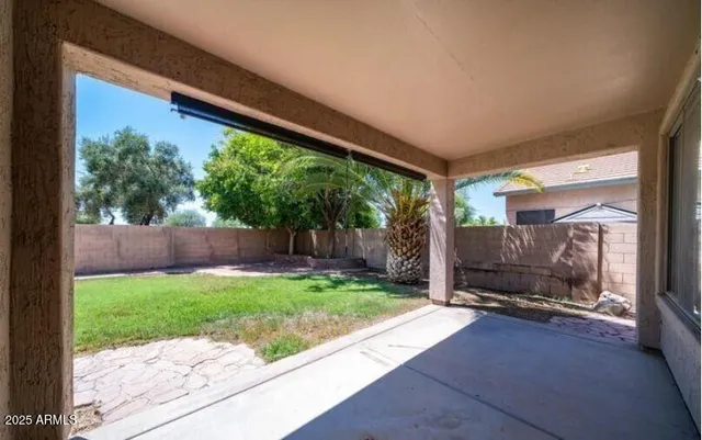 a view of a patio with a table and chairs