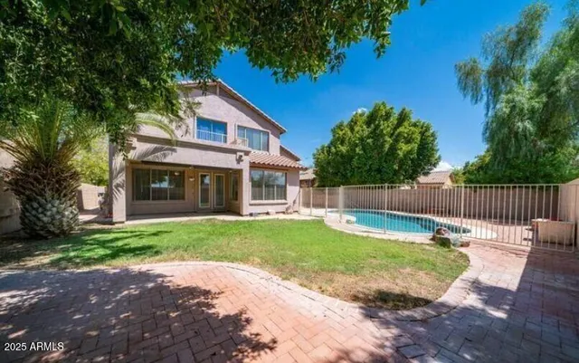 a view of a house with backyard and sitting area