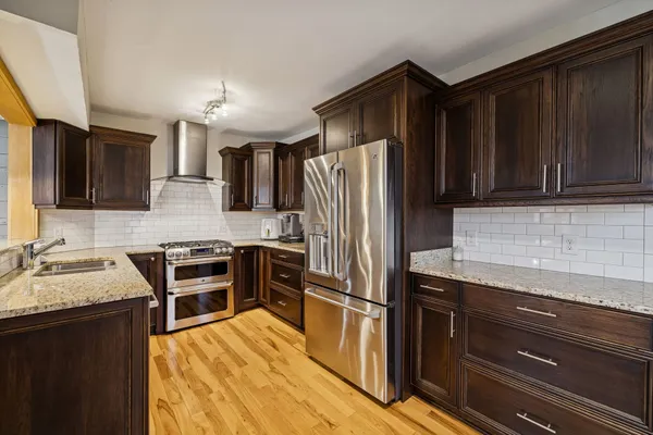 a kitchen with granite countertop stainless steel appliances and wooden cabinets