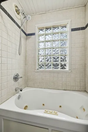 a bathroom with a bathtub and shower
