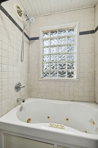 a bathroom with a bathtub and shower